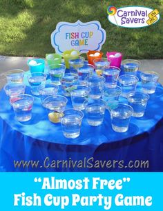 there are many cups on the table with fish cup game in front of them and a sign that says carnival savers