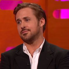 a man in a black suit and white shirt