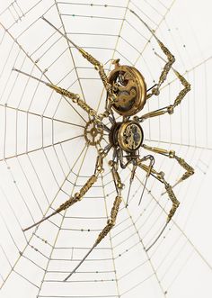 an image of a spider with gears on it's back legs in the middle of its web