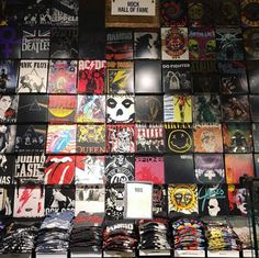 a wall covered in lots of different types of shirts and t - shirt designs on display