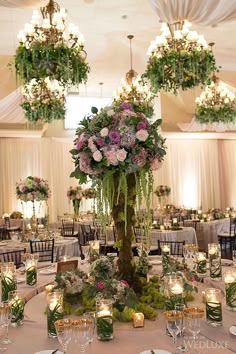 the centerpieces are filled with flowers and greenery