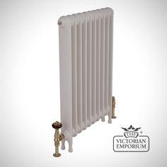 the victorian radiator is white and has brass fittings on both sides,