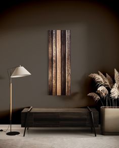 a living room with a couch, lamp and wooden paneled wall hanging on the wall