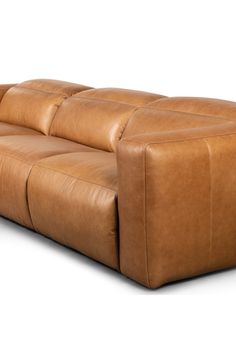 a brown leather couch sitting on top of a white floor