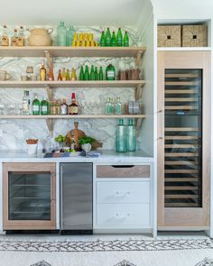 a kitchen with lots of bottles on the shelves