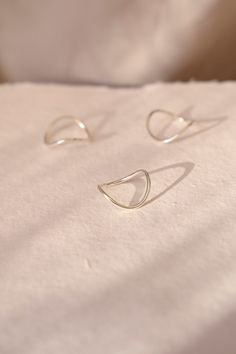 Inspired by our smallest rivers, largest oceans and the ebb and flow of life itself, the Sterling Silver Flow Ring | Eco friendly Jewellery | Curved Ring | Curvy Silver Ring | Stacking Ring | Everyday Ethical Jewellery | Minimal takes minimalism and adds a handmade unique feel to it. This is our go-to collection for those who love simple jewellery with a hint of movement. Founded and led by women, our jewellery is handmade in London UK, using recycled and traceable silver and solid gold with ethical processes, perfect for those who prefer a sustainable and environmentally conscious eco-friendly lifestyle. -Sizing- You can choose any size, the below is for guidance. Small is UK ring size L (USA size 5.75). Diameter 16.3mm. Circumference 51.2mm Medium is UK ring size N (USA size 6.75) Diamet Jewellery Minimal, Curved Ring, Simple Jewellery, Curve Ring, Ring Everyday, Ebb And Flow, Eco Friendly Jewelry, Ring Stacking, Ethical Jewelry