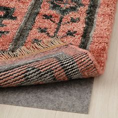 an orange and black rug on the floor