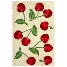 a white rug with red cherries on it