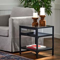 a living room scene with focus on the end table and chair, which has candles on it