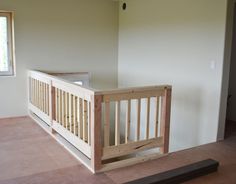 an empty room with a wooden crib in it