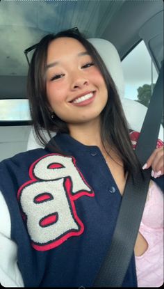 a woman sitting in the back seat of a car with her hand on her hip