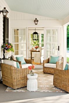 an outdoor living room with wicker furniture