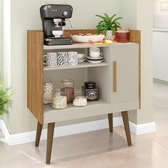 a coffee maker is sitting on top of a small shelf with food and drinks in front of it