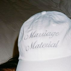 a white hat with the words marriage material written on it