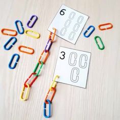 some paper clips and numbers on a table