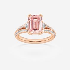 a pink tourmaline ring with diamonds on the sides and an emerald stone in the center