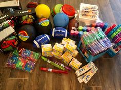 many toys and supplies are laid out on the floor next to each other in boxes