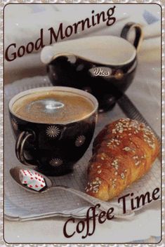 a cup of coffee, croissant and spoon on a tray with the words good morning