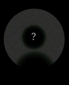 a black circle with a question mark on it in the middle, and dark background