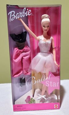 barbie ballerina doll in pink and white dress with black cat on the back side