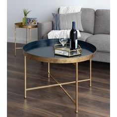 a living room with a couch, coffee table and wine bottle on the end table