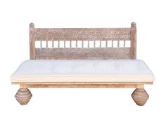 an old wooden bench with a mattress on it's backrest and two legs