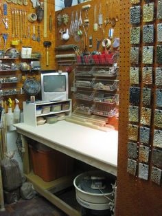 a room filled with lots of crafting supplies and tools on the wall next to it