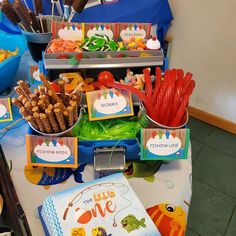 there are many items on the table for children's birthdays to eat and drink