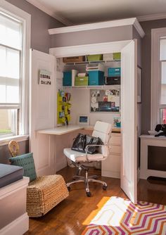 a room with a chair, desk and shelves on the wall next to a window