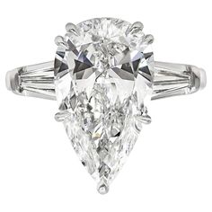 an oval cut diamond ring with baguetts on the shoulders