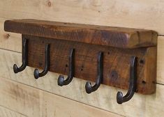 an old wooden coat rack with four hooks