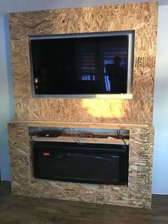 a flat screen tv mounted to the side of a fireplace