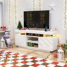 a living room with christmas decorations on the wall and a flat screen tv in the corner