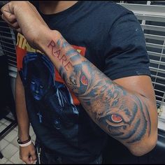 a man with a tiger tattoo on his arm