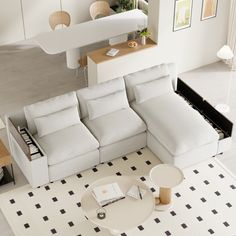 a living room with a white couch and coffee table in front of the sectional sofa