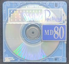 a cd that is sitting on top of a blue plastic case with the word pmd 80 printed on it