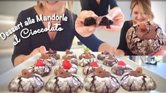 a woman holding up a piece of chocolate covered dessert