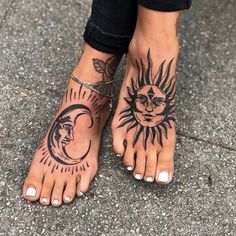 a woman's feet with sun and moon tattoos on their ankles, while standing in the street