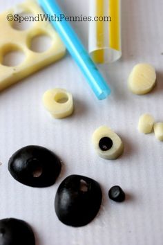 some black and white items are laying out on a table with one blue toothbrush