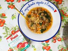 a bowl of soup with meat and vegetables on a table next to a packet of tomato seeds