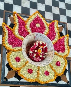 an overhead view of a flower arrangement in the middle of a checkerboard floor