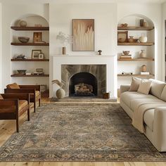 a living room filled with furniture and a fire place