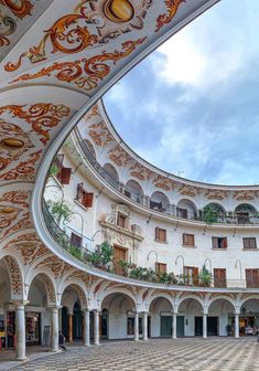 the inside of an ornate building with many arches and balconies on each side