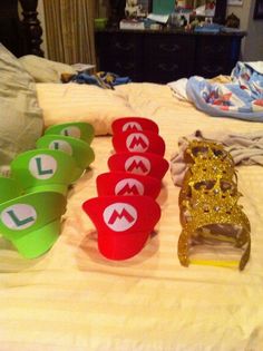 four plastic cups sitting on top of a bed next to each other with the word love spelled across them