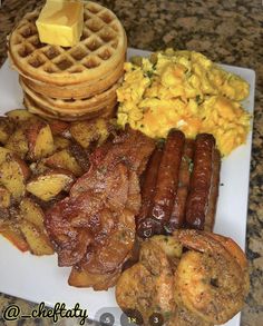 a white plate topped with breakfast foods and waffles