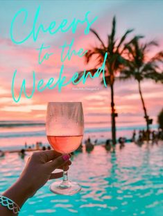 a person holding a wine glass in front of a swimming pool with palm trees and the words cheers to the weekend