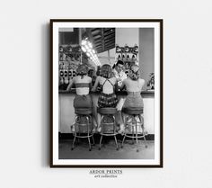 black and white photograph of three women sitting at a bar