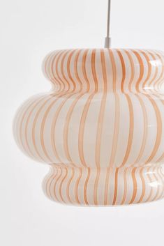 an orange and white striped light hanging from a ceiling