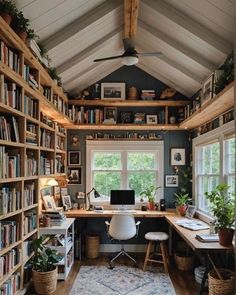 a home office with lots of bookshelves and plants