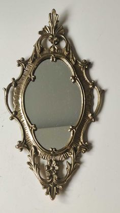 an ornate gold mirror hanging on the wall